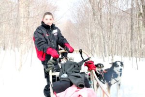 A young cancer patient on the dog sled Credit: Emmanuelle Compte